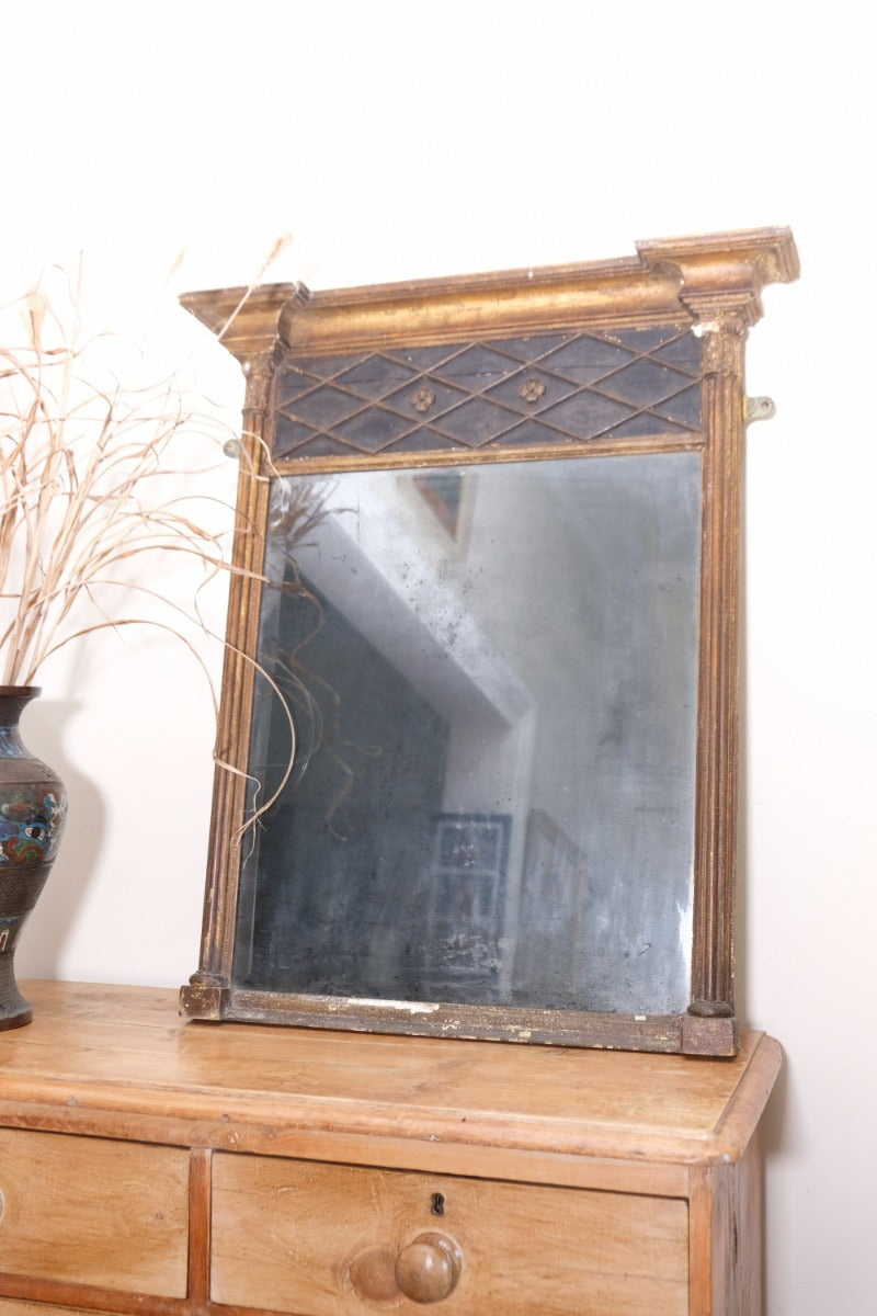 Close‑up of original foxed glass on antique gilt pier mirror
