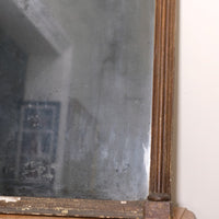 Close‑up of original foxed glass on antique gilt pier mirror