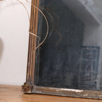 Close‑up of original foxed glass on antique gilt pier mirror