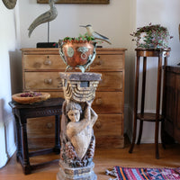 Antique carved polychrome putto pedestal with aged patina