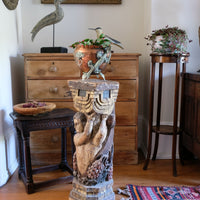 Antique carved polychrome putto pedestal with aged patina