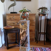 Antique carved polychrome putto pedestal with aged patina