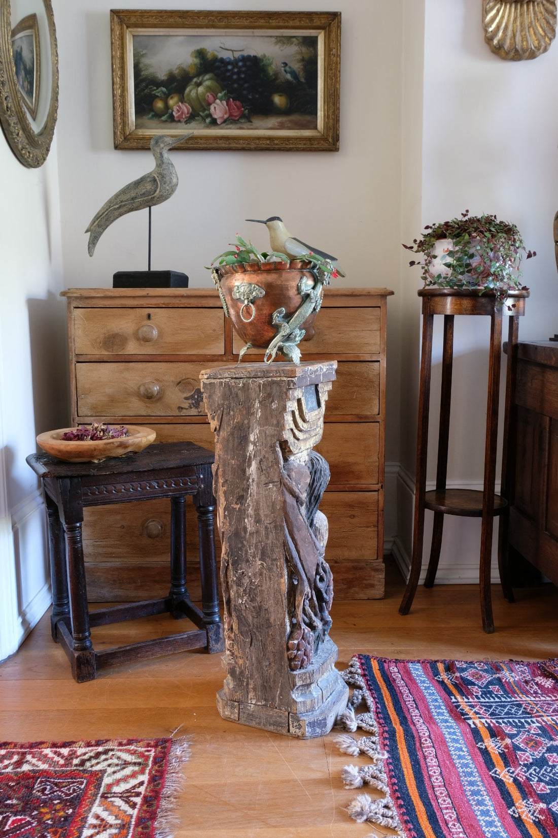 19th-century carved polychrome putto pedestal sculpture with grape motif