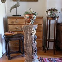 Antique carved polychrome putto pedestal with aged patina