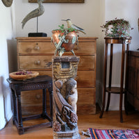 19th-century carved polychrome putto pedestal sculpture with grape motif