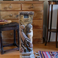 Antique carved polychrome putto pedestal with aged patina