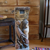 Antique carved polychrome putto pedestal with aged patina