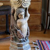 Antique carved polychrome putto pedestal with aged patina