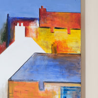 Abstract painting of a house with bold colors on a wall.
