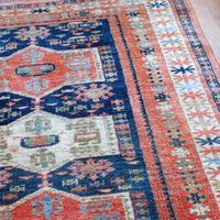 Decorative rug with intricate patterns on a wooden floor