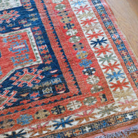 Close-up of a patterned rug on a wooden floor