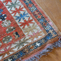 Colorful patterned rug on a wooden floor