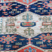 Kazak wool rug with shield kazak medallions