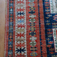 Kazak wool rug with shield kazak medallions