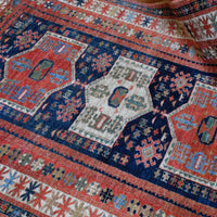 Kazak wool rug with shield kazak medallions