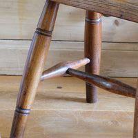 Antique elm and ash farmhouse stool with hand hole, circa 1860"
"Rustic 19th century wooden stool with turned baluster legs