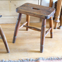 Antique elm and ash farmhouse stool with hand hole, circa 1860"
"Rustic 19th century wooden stool with turned baluster legs