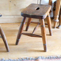 Antique elm and ash farmhouse stool with hand hole, circa 1860"
"Rustic 19th century wooden stool with turned baluster legs