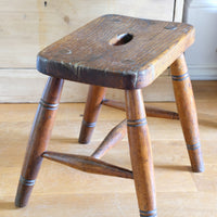 Antique elm and ash farmhouse stool with hand hole, circa 1860"
"Rustic 19th century wooden stool with turned baluster legs