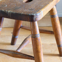 Antique elm and ash farmhouse stool with hand hole, circa 1860"
"Rustic 19th century wooden stool with turned baluster legs