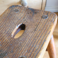 Antique elm and ash farmhouse stool with hand hole, circa 1860"
"Rustic 19th century wooden stool with turned baluster legs