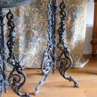 Antique ornate cast iron tripod tables circa 1900s matching pair