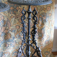 Antique ornate cast iron tripod tables circa 1900s matching pair