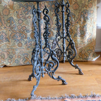 Antique ornate cast iron tripod tables circa 1900s matching pair