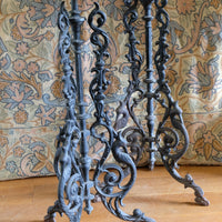 Antique ornate cast iron tripod tables circa 1900s matching pair