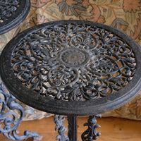 Antique ornate cast iron tripod tables circa 1900s matching pair