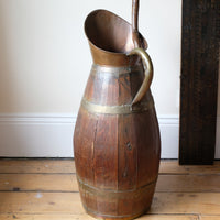 Large 19th-century oak and brass cider jug used as a walking stick and umbrella stand