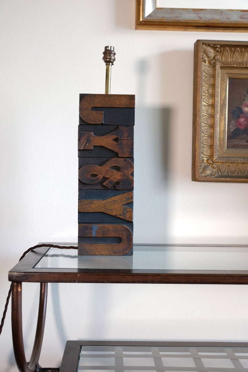 Close‑up of printing block letters forming lamp base