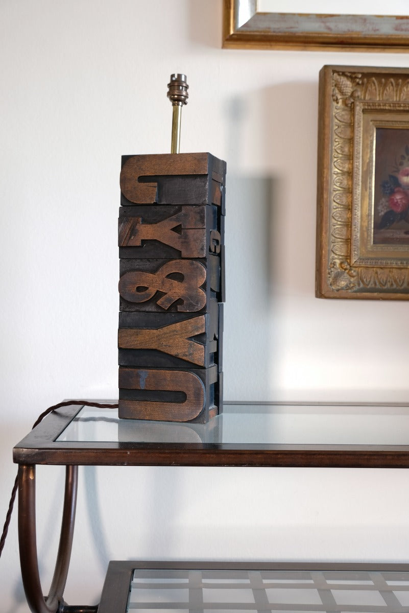 Close‑up of printing block letters forming lamp base