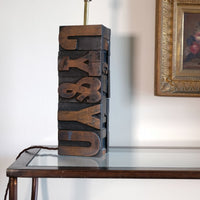 Close‑up of printing block letters forming lamp base