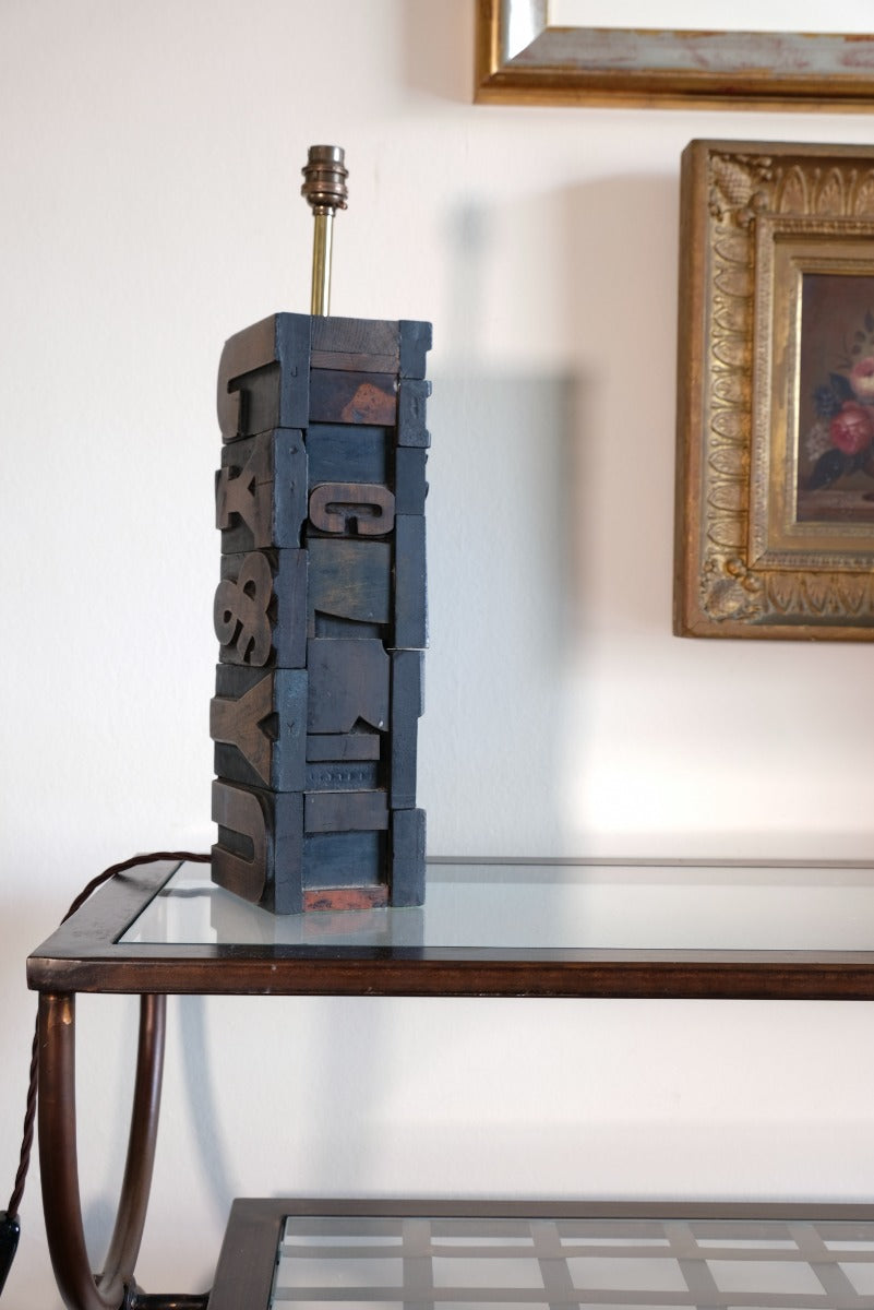 Close‑up of printing block letters forming lamp base