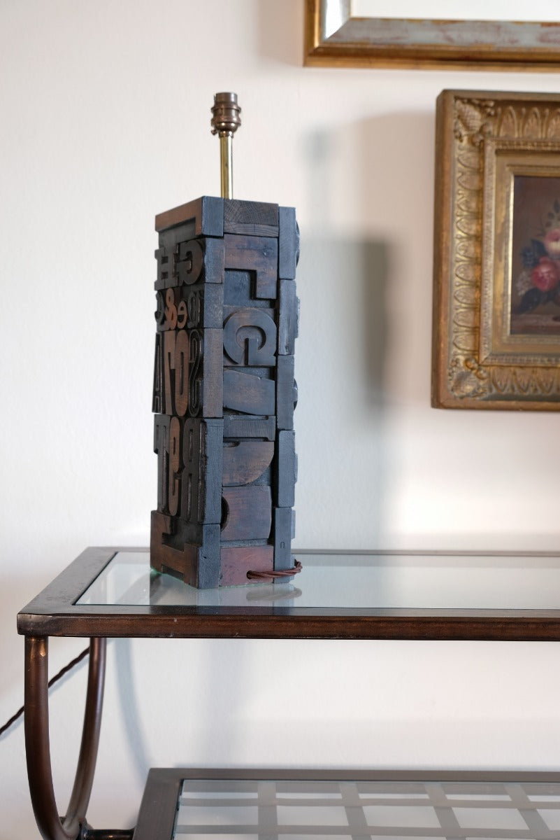 Close‑up of printing block letters forming lamp base