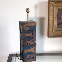 Close‑up of printing block letters forming lamp base