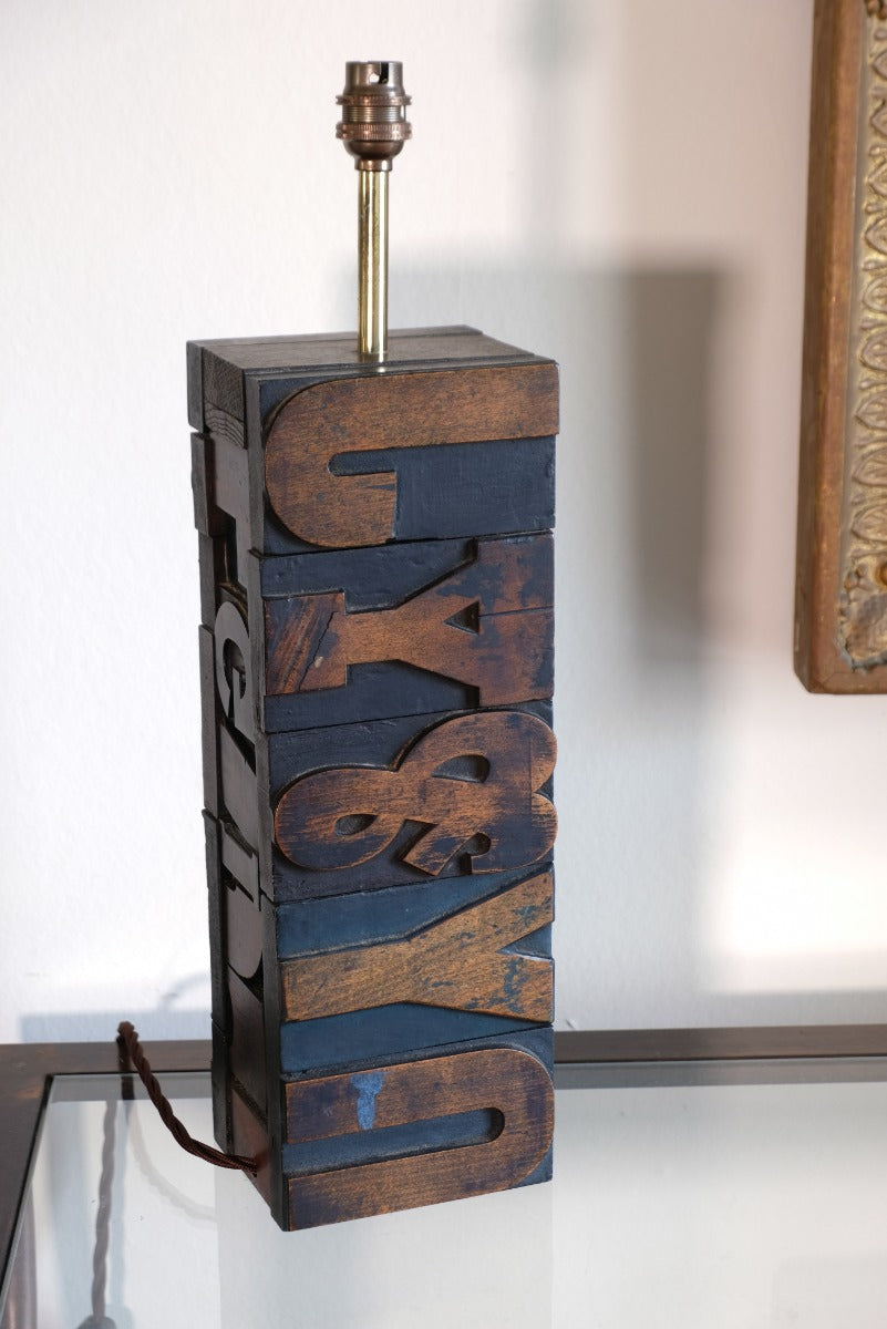 Close‑up of printing block letters forming lamp base
