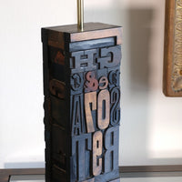 Close‑up of printing block letters forming lamp base