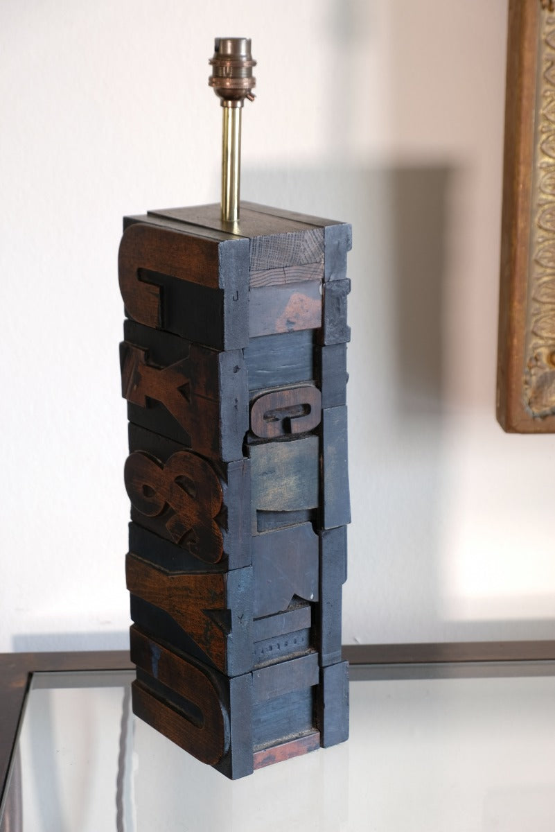 Close‑up of printing block letters forming lamp base