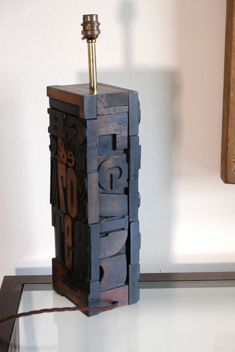 Close‑up of printing block letters forming lamp base