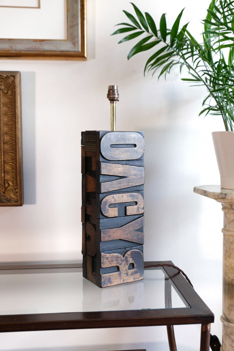 Close‑up of printing block letters forming lamp base