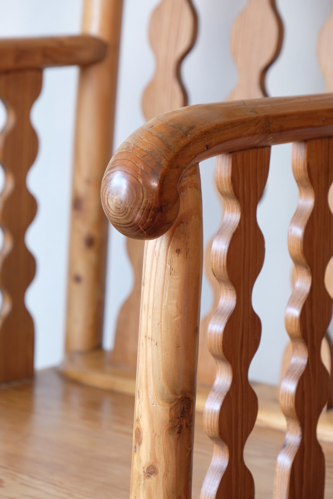 Hand‑curl armrest of pitch pine bobbin armchair