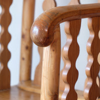 Hand‑curl armrest of pitch pine bobbin armchair