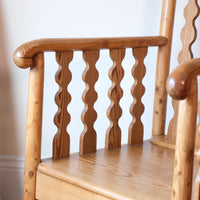 Hand‑curl armrest of pitch pine bobbin armchair