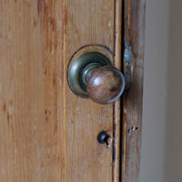 Close up brass latch on Victorian pine cupboard