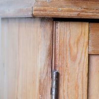 Close up brass hinge on Victorian pine cupboard