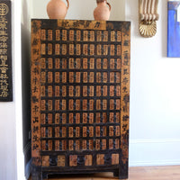 Painted Chinese bank of 57 drawers with hand-painted calligraphy