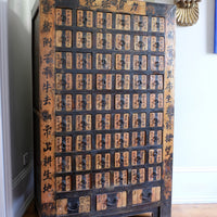 Painted Chinese bank of 57 drawers with hand-painted calligraphy