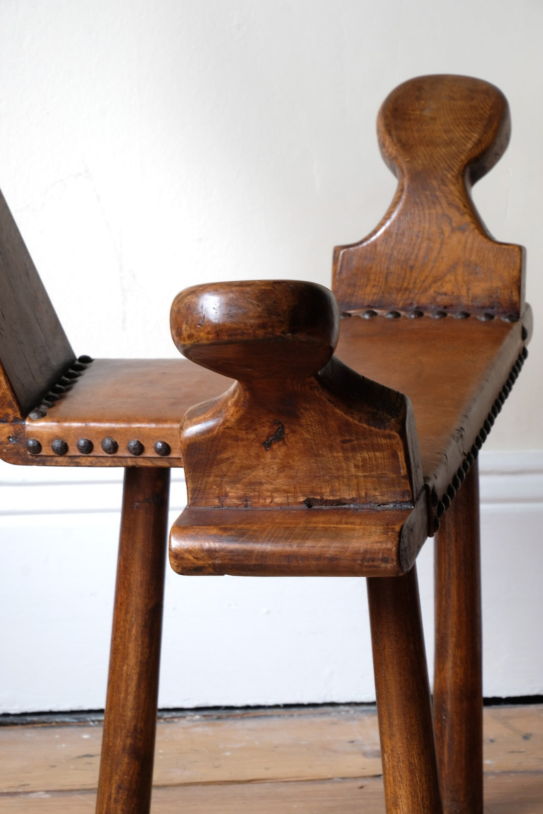 Side profile with sculptural arms and tripod base